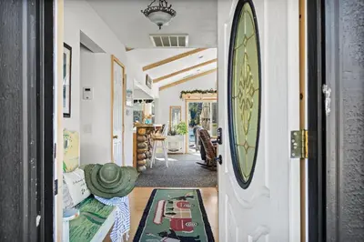a hallway with a door leading to a living room at Boulder Bay Waterfront Breeze in Big Bear Lake