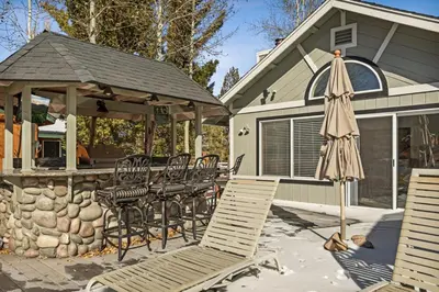 a group of chairs and an umbrella on a patio at Boulder Bay Waterfront Breeze in Big Bear Lake