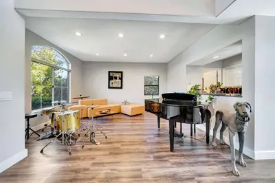 a living room with a piano and a drum kit at Stunning Hilltop 5BR With View And Hot Tub! in Lakeside Park