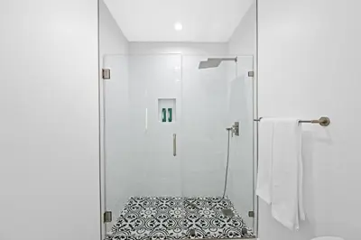 a bathroom with a shower with a glass door at Spanish Style Guesthouse Unit 1 in Los Angeles