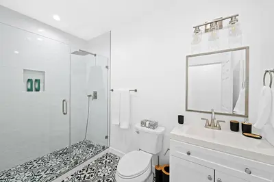 a bathroom with a shower and a toilet and a sink at Spanish Style Guesthouse Unit 1 in Los Angeles