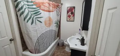 a bathroom with a shower curtain and a sink at Private 3 bedroom Home in Los Angeles - Gardena, California in Gardena