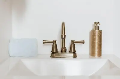 a bathroom sink with two faucets on it at Off The Hook in Big Bear Lake in Big Bear Lake
