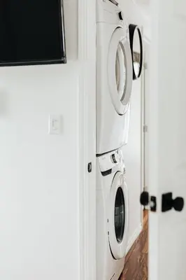 a washing machine in a bathroom next to a door at Off The Hook in Big Bear Lake in Big Bear Lake