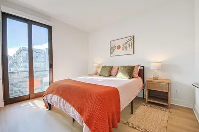 a bedroom with a bed and a large window at Beachside 2BD 2BA, 12Min Walk to Santa Monica Pier in Los Angeles