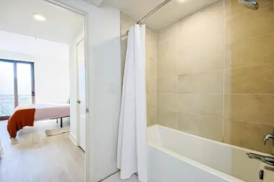 a bathroom with a shower and a bath tub at Beachside 2BD 2BA, 12Min Walk to Santa Monica Pier in Los Angeles