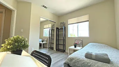 a small bedroom with a bed and a mirror at Blue Private Room near BMO Stadium USC and K-Town in Los Angeles