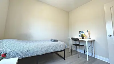 a bedroom with a bed and a table and a chair at Blue Private Room near BMO Stadium USC and K-Town in Los Angeles