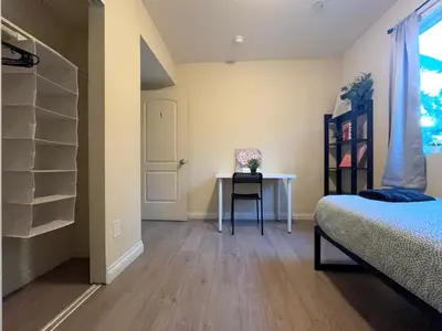 a bedroom with a bed and a table and a desk at Blue Private Room near BMO Stadium USC and K-Town in Los Angeles