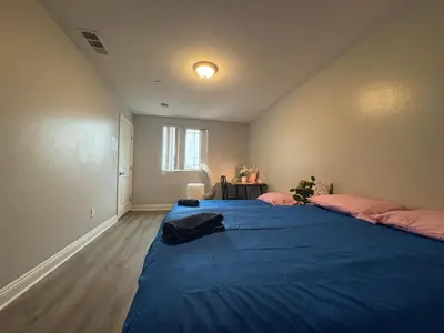 a bedroom with two beds with a blue blanket at Blue Stay near BMO Stadium and USC Private Room in Los Angeles