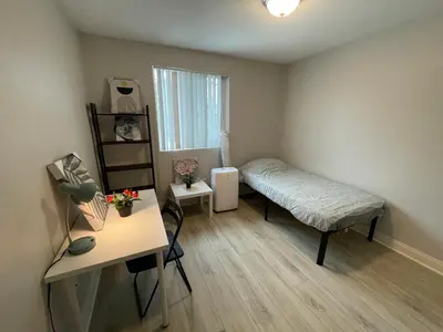 a small bedroom with a bed and a desk at Blue Stay near BMO Stadium and USC Private Room in Los Angeles