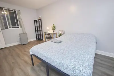 a white room with a bed and a table at Blue Stay near BMO Stadium and USC Private Room in Los Angeles