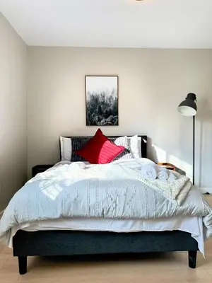 a bedroom with a large white bed with red pillows at Fire Support 3Bedroom Modern Luxury House in Central Pasadena in Pasadena
