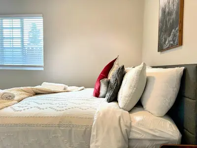 a bedroom with a bed with pillows on it at Fire Support 3Bedroom Modern Luxury House in Central Pasadena in Pasadena