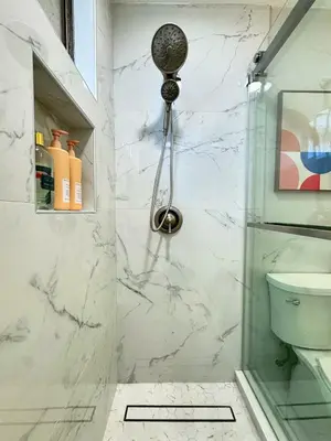 a bathroom with a shower and a toilet at Fire Support 3Bedroom Modern Luxury House in Central Pasadena in Pasadena