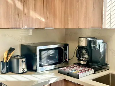 a microwave sitting on a counter next to a coffee maker at Fire Support 3Bedroom Modern Luxury House in Central Pasadena in Pasadena