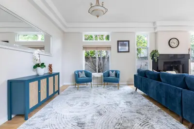 a living room with blue furniture and a fireplace at Tranquil family beach city retreat in Redondo Beach