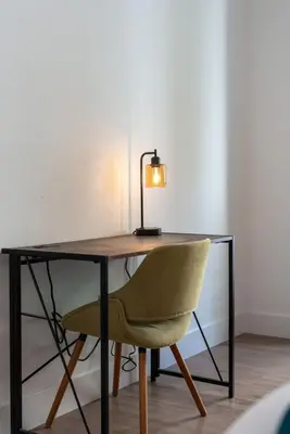a desk with a chair and a lamp on it at Amethyst Horizon - Stylish peaceful 2BR w zen Garden View Pool Gym in Los Angeles