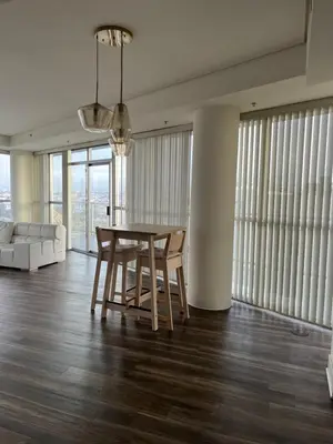 a dining room with a table and chairs and a couch at NoHo in Los Angeles