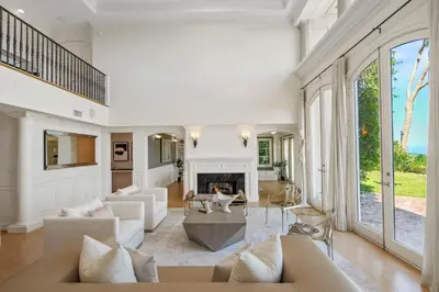 a living room with white furniture and a fireplace at Savona Sanctuary Estate in Los Angeles