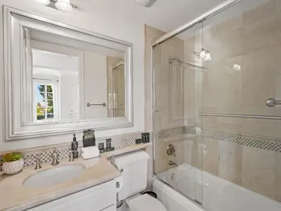 a bathroom with a toilet and a sink and a mirror at Savona Sanctuary Estate in Los Angeles
