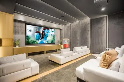 a living room with white couches and a tv at Hutton Modern in Beverly Hills