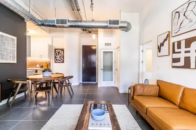 a living room with a couch and a table at DTLA 2BR Rooftop Jacuzzi & Sunset Views in Los Angeles