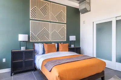 a bedroom with a bed and two night stands with lamps at DTLA 2BR Rooftop Jacuzzi & Sunset Views in Los Angeles