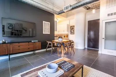a living room with a table and a dining room at DTLA 2BR Rooftop Jacuzzi & Sunset Views in Los Angeles