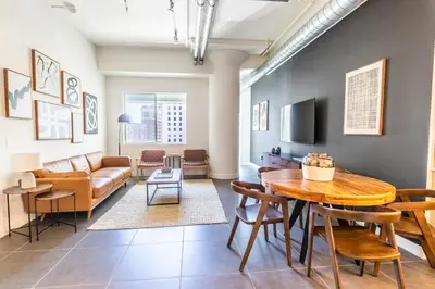 a living room with a table and a couch at DTLA 2BR Rooftop Jacuzzi & Sunset Views in Los Angeles