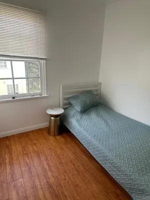 a bedroom with a bed and a table in it at Cute room in best area of Hollywood in Los Angeles