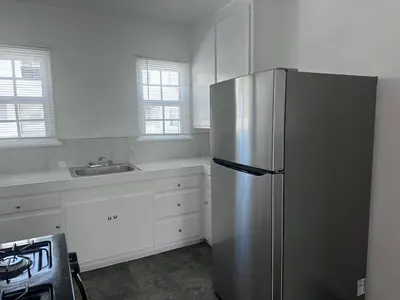 a kitchen with a stainless steel refrigerator and a sink at Cute room in best area of Hollywood in Los Angeles