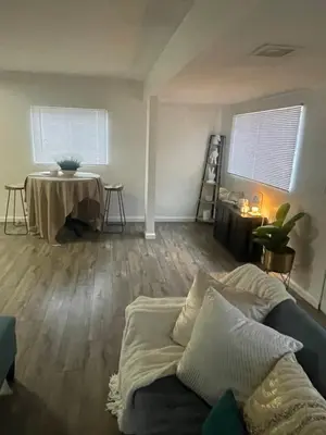 a living room with a couch and a table at Sofi Intuit Forum Vacation Oasis in Los Angeles