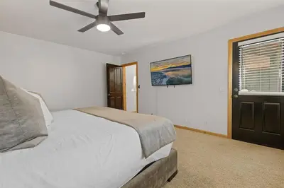 a bedroom with a bed and a ceiling fan at NEW Serenity Lodge Base Of Snow Summit Hot Tub in Big Bear Lake