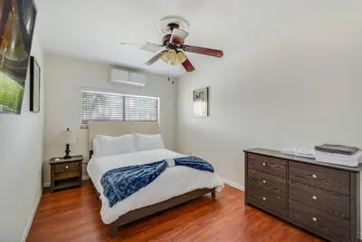 a bedroom with a bed and a ceiling fan at Newly Renovated Home Spacious Close 2 Hospital in San Bernardino