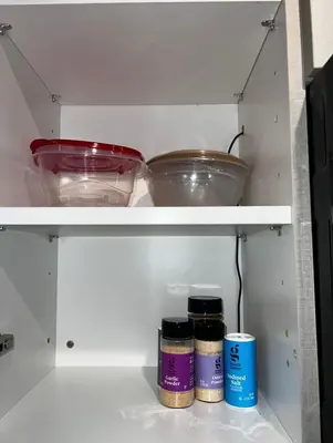 a white cabinet with two bowls and jars on it at Modern Hollywood Walk of Fame Apts- Free Parking, 360 Rooftop, Pool, Gym- Centrally located in Los Angeles