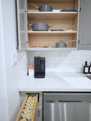 a kitchen with a counter with cupcakes on shelves at Modern Family Haven - Minutes from Disney Magic-OC in Midway City
