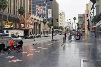 a wet city street with stars on the sidewalk at Beverly Hills Charm Rodeo Cedar in Los Angeles