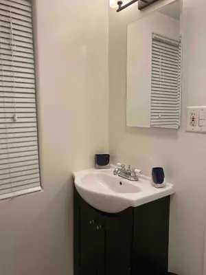 a bathroom with a sink and a mirror at Serene Sherman Oaks Cottage with Outdoor Space in Los Angeles