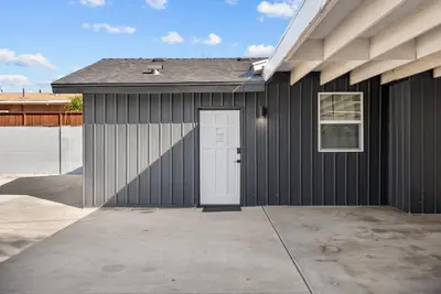 a black garage with a white door and a driveway at Perfect 2BR Near Universal Studios By Poshguest in San Fernando