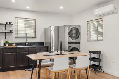 a kitchen with a table and chairs and a refrigerator at Perfect 2BR Near Universal Studios By Poshguest in San Fernando
