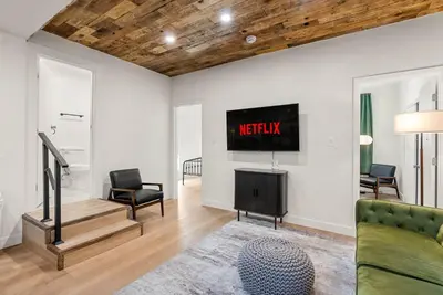 a living room with a tv on the wall at Perfect 2BR Near Universal Studios By Poshguest in San Fernando