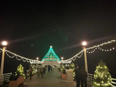 a christmas market with lights and christmas trees at Manhattan Beach Oasis in Manhattan Beach