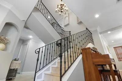 a staircase in a home with a chandelier at Los Angeles Large Mediteranian Vacation Home in Sherman Oaks Community Hospital Heliport