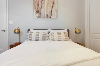 a bedroom with a white bed with two lamps at Los Angeles Large Mediteranian Vacation Home in Sherman Oaks Community Hospital Heliport