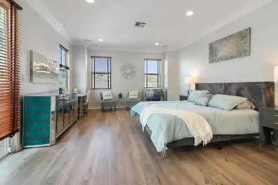 a bedroom with a large bed and a desk at Los Angeles Large Mediteranian Vacation Home in Sherman Oaks Community Hospital Heliport
