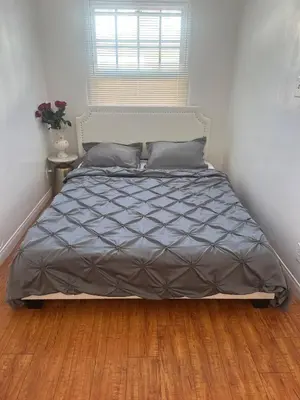 a bed in a bedroom with a wooden floor at Best location of Hollywood, great room in 2bdrm apt, walk of fame in Los Angeles