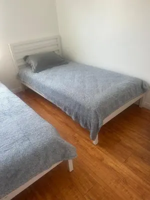 a bedroom with two beds in a room with wood floors at Best location of Hollywood, great room in 2bdrm apt, walk of fame in Los Angeles