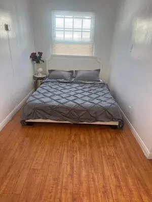 a bed in a bedroom with a wooden floor at Best location of Hollywood, great room in 2bdrm apt, walk of fame in Los Angeles