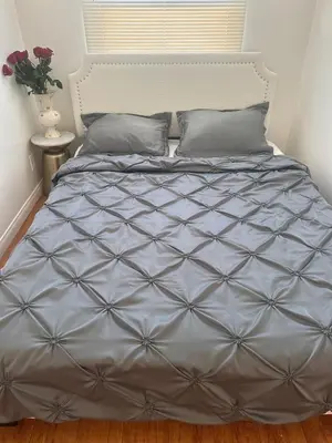 a bed with a gray comforter in a bedroom at Best location of Hollywood, great room in 2bdrm apt, walk of fame in Los Angeles